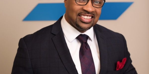 Staff member Shah Washington posing for a photo